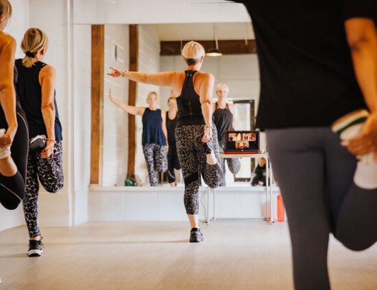 A group of people stretching their legs after a fitness class