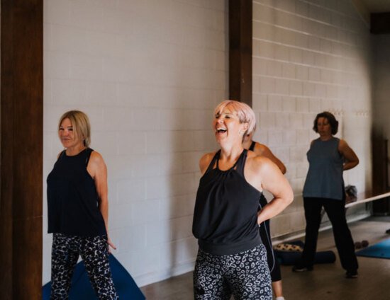 A group of women stretching after a fitness class